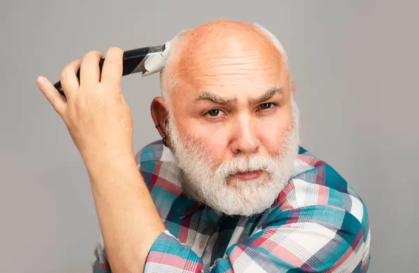 Gray man hair clippings. Bald man hairclipper, Mature baldness and hair loss concept