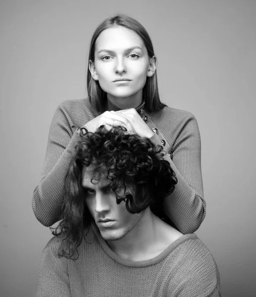 Close up portrait self-confident young woman and serious dissatisfied man with stylish hairstyle. Attractive couple together. The beginning of life of a young couple. The first joint family decisions