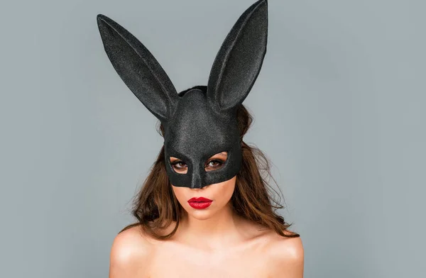 Bunny woman. Beautiful naked girl in fashion bunny mask. Egg hunt. Easter rabbit ears