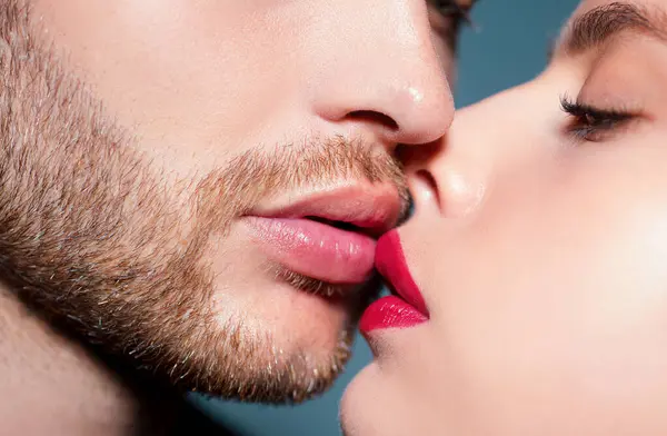 Man with woman kisses, macro, cropped of face. Sensual couple kissing. Kiss lovers lips
