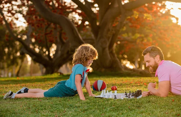 Otec Syn Hrají Šachy Ležící Trávníku Parku Den Otců Rodina — Stock fotografie