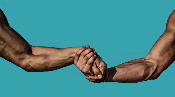 Helping hand, support. Close up help hand. Two hands, helping arm of a friends, teamwork. Rescue, helping gesture or hands. Strong hold. Handshake, arms, friendship and teamwork. Muscular men arms