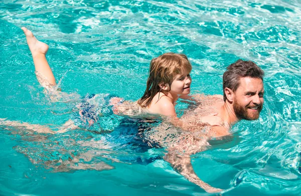 Father and son swimming in pool, summer family. Dad and son leisure. Swimming lessons