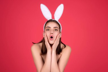 Easter bunny girl wear easter fluffy bunny ears hold easter eggs, isolated studio background. Eater portrait of female bunny