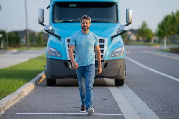 Hispanic driver near lorry truck. Man owner truck driver. Handsome hispanic man trucker trucking owner. Transportation industry vehicles. Handsome man driver front of truck