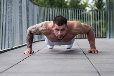 Sportsman muscular man workout in gym. Athletic man exercising with dumbbell. Fitness, sports concept, sport club, fitness center. Workout in gym. Sexy guy bodybuilder with perfect muscles body