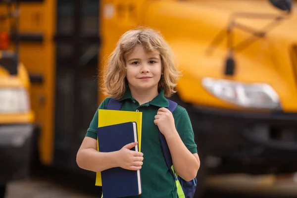 Schoolkid getting on the school bus. American School. Back to school. Kid of primary school. Happy children ready to study. Educational concept