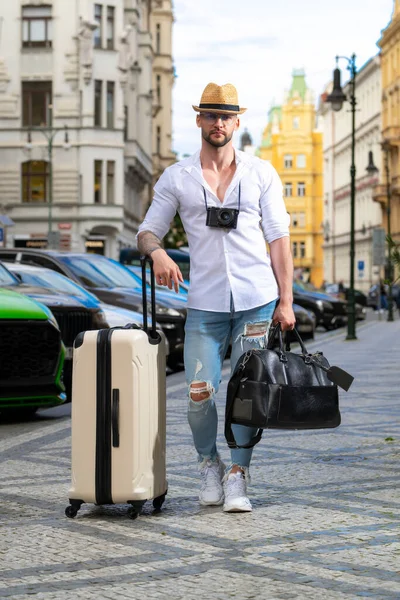 Travelling concept. Photo of man travel with travel bag. Man with suitcase dreams of travel, adventure, vacation