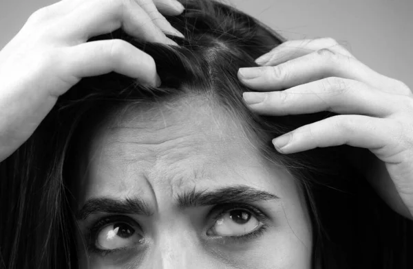 Sad woman with hair loss problem worried about hair loss