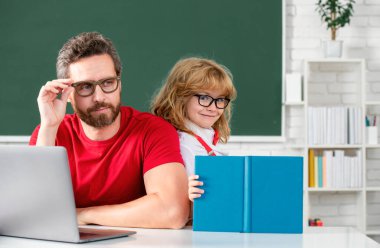 Teacher and pupil boy learning in the classroom. Teacher and little student portrait, teachers day