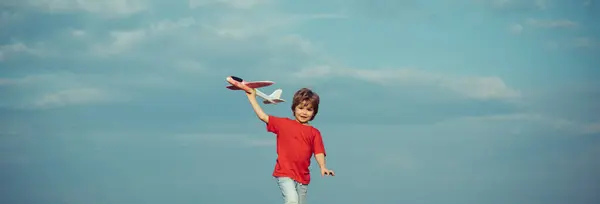 春と子供たち ウェブサイトのヘッダーのためのバナー おもちゃの飛行機で遊ぶ子供は楽しさと笑顔を持っています — ストック写真