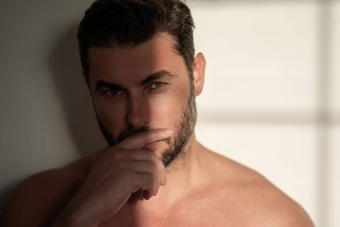Seksi üstsüz adam, beyaz arka planda izole edilmiş teninin portresini kapat. Yumuşak ciltli, çekici bir adam. Spa terapisi. İnsan, yüz, güzellik ve cilt konsepti