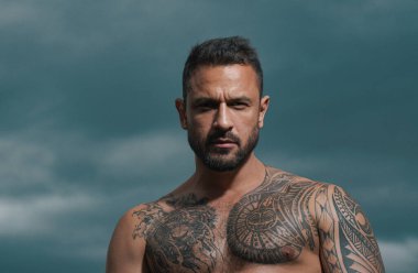 Ciddi yüzlü yakışıklı bir adamın portresi. Çıplak ve güçlü gövde.