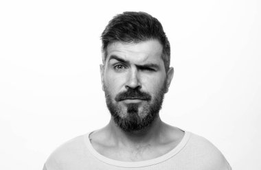 Serious man portrait. Beard and mustache. Looks seriously. Isolated. Hipster guy face expression. Closeup face