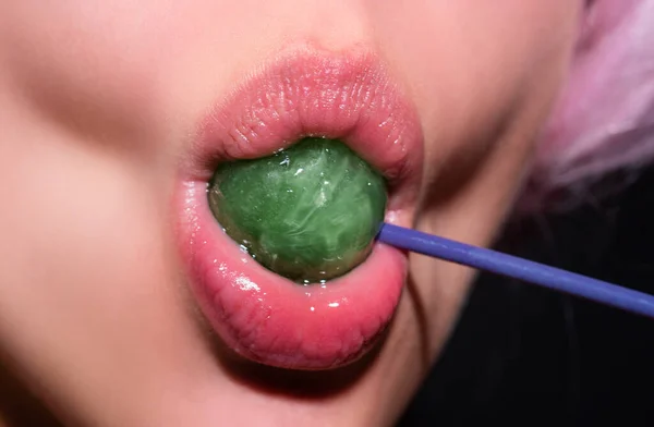 Sucking lips. Lips with candy, sexy sweet dreams. Female mouth licks chupa chups, sucks lollipop
