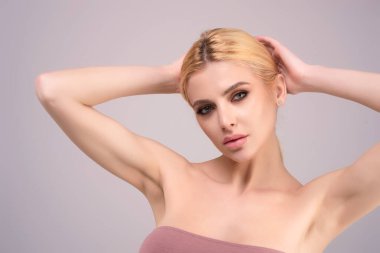 Close-up portrait of lovely pretty girl isolated over studio background. Beauty woman with perfect skin. Makeup and cosmetics. Natural makeup for beauty salon. Care cosmetics, face and body skin care