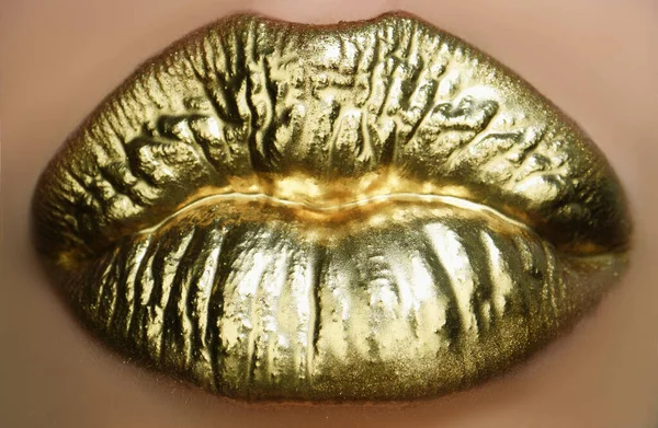 Golden make up. Colorful sexy lips, golden art. Gold bright make-up in lips. Golden lip texture