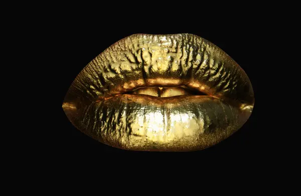 Gold lips. Gold paint from the mouth. Golden lips on woman mouth with make-up. Sensual and creative design for golden metallic. Golden lip texture