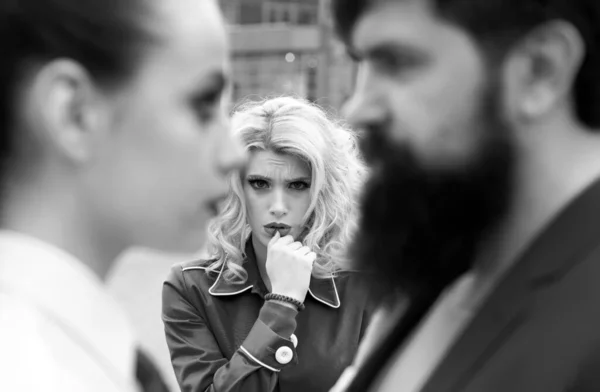 Obsessed ex girlfriend spying to a couple dating. She is obviously jealous. Bearded man cheating his girlfriend with another woman. Unhappy girl feeling jealous