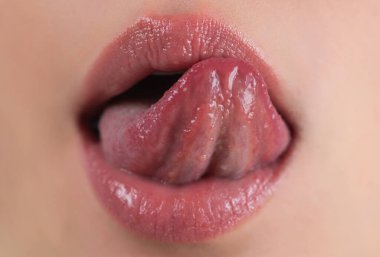 Seksi dudaklar. Tombul parlak dudak. Dilini çıkar. Dişilerin dillerini çıkarıp dudaklarını yaladığı yakın plan. Makro dil dudakları yalar. Dilinle kadın ağzını kapat. Seksi diller. Şehvetli dudakları yala