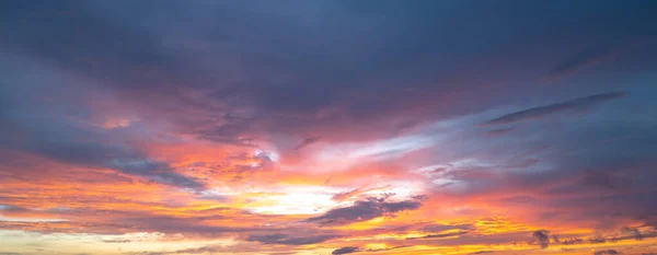 Sunrise background. Dramatic majestic scenery sunset. Sky with clouds in Sunrise sky light background. Sunrise with clouds in various shapes. Calm Sunrise sky and sun through clouds over