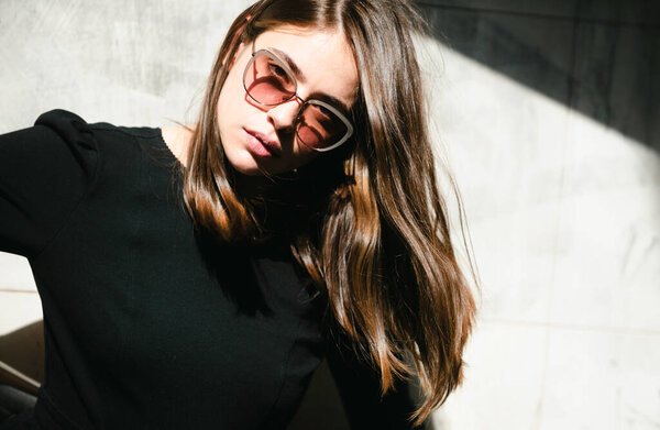Beautiful young woman in the city street. Beautiful young fashion woman in sunglasses