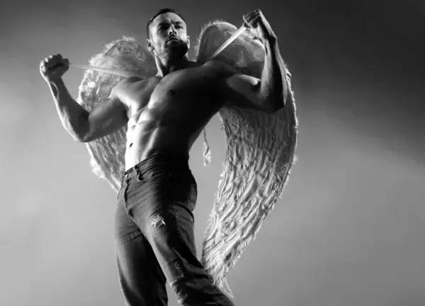 Muscular male model. Man with angels wings