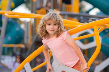 Happy kids having fun on playground. Adorable little child boy having fun on playground