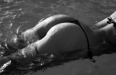 Summer vacation. Sexy woman ass buttocks. Girl in bikini on sea water background with copyspace. Sexy buttocks