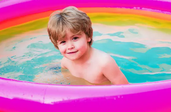 Kids beach fun. Kids learn to swim. Child swimming pool. Happy little boy playing in swimming pool outdoor on hot summer day. Healthy outdoor sport activity for children