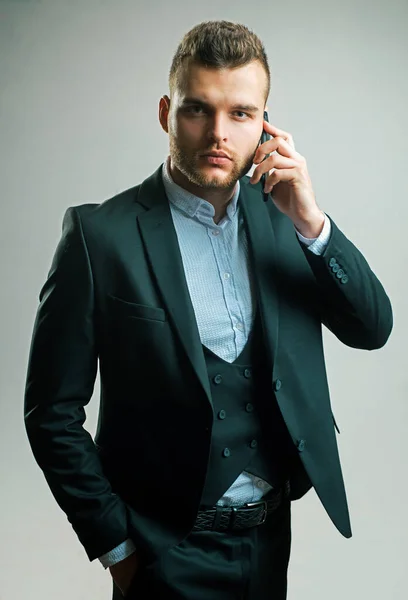 Man in suit using smart phone. Business man in work with phone mobil. Luxury classic suits, vogue. Man fashion. Meeting phone. Main responsibility. Useful nowadays. Discussing the current project.