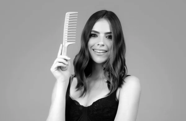 Woman brushing straight natural hair with comb. Girl combing long healthy hair with hairbrush. Hair care beauty concept. Brushing Hair