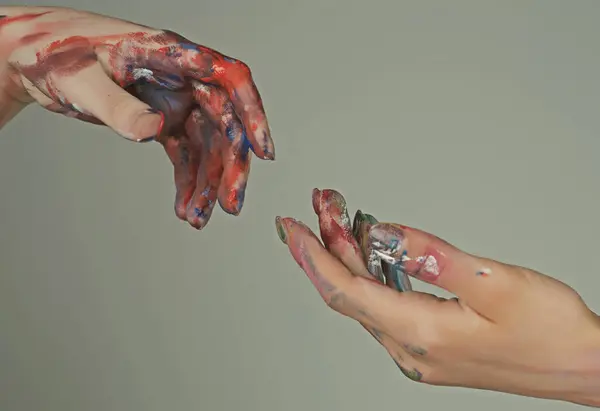 Painted hands. Reach hand. Sensual touch fingers. Two hands trying to touch. Male and female hands reaching to each other. Hand try to touch. Fingers touch each other. Sensual arms