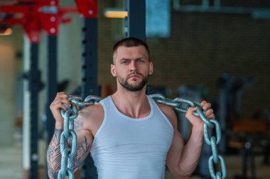 Muscular athletic fit man hard workout fitness in gym. Sport fitness and bodybuilding. Strong muscular doing exercise in the gym. Sexy muscular male body. Fitness man in the gym. Fitness training