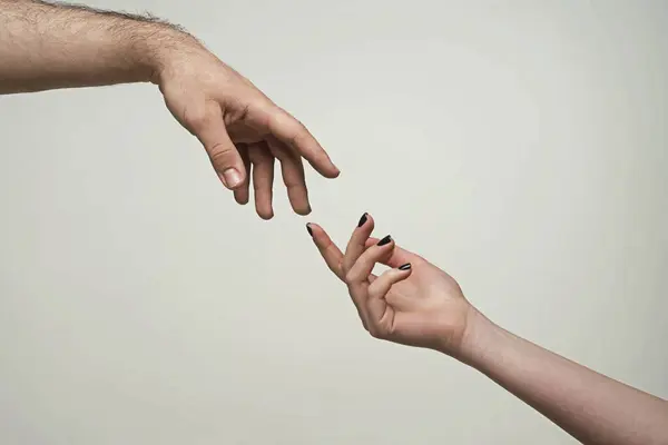 Touch of two hands. Man and woman hand about to touch with index finger. Couple hands reaching to each other. Hand try to touch. Two hands reaching towards each other. Couple hand touch