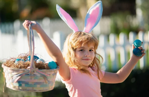 Excited child with easter basket. Easter bunny child boy with cute face. Kids hunting easter eggs. Happy easter holiday