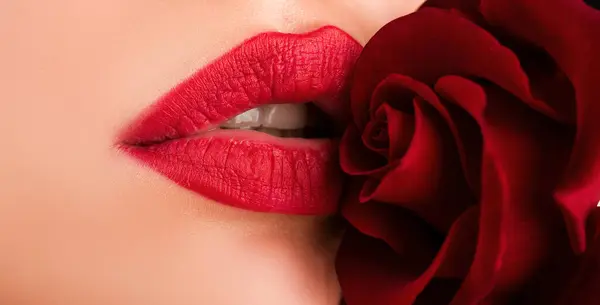 Sexual full lips. Natural red gloss of lips and womans skin. Lips with lipstick closeup. Beautiful woman lips with rose