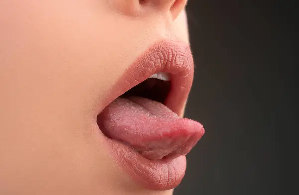 Sexy open mouth with tongue. Sensual red lips. Passion kiss. Oral sex