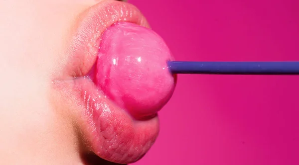 Sexy woman mouth with pink lips holding lollipop, beauty closeup. Sexy girl suck lick lollipop. Beauty glamour concept, close-up