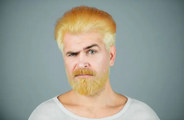 Barbershop. Dyed man hair. Blonde guy with long beard and moustache