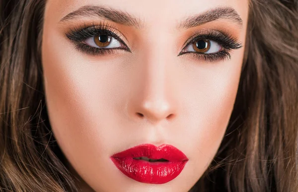 Closeup makeup with red lips. Smokye eyes. Cosmetics products