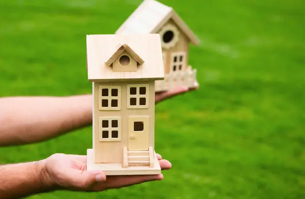 Insurance agent with toy house. The concept of property insurance protection and housing. Security and safety in the home. Real estate. Neighbors house concept
