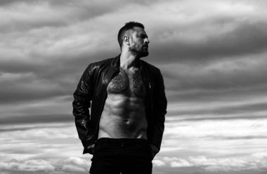 Brutal angry gang man lifestyle, serious handsome guy. Fashion male model with leather jacket