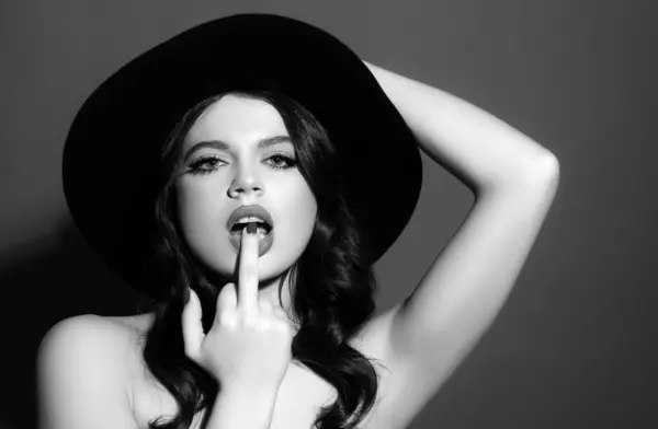 Sexy woman licking middle finger. Fuck you concept. Offensive gesture. Middle finger girl