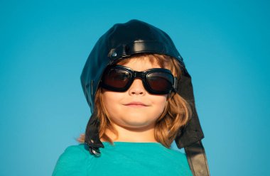 Çocuklar rüya görür. Pilot kasklı, gözlüklü, komik portresi olan beyaz bir çocuk. Çocuk yüzü