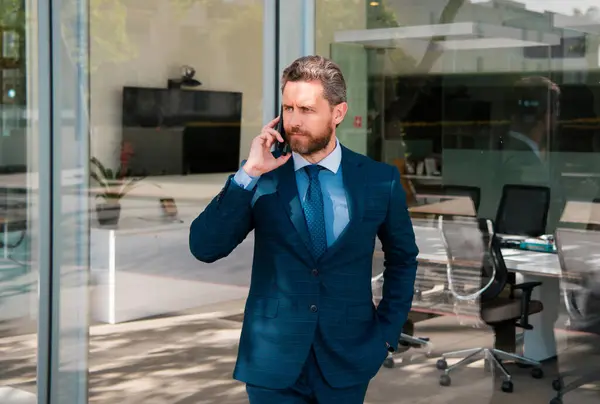 Business man using smartphone. Businessman talking on phone