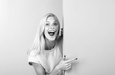 Woman pointing finger on blank board. Woman standing behind the white blank banner or empty copy space advertisement board.