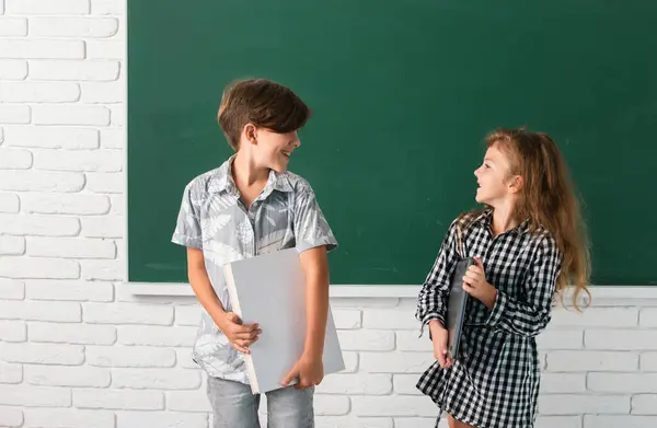 School Children Each Other Hold Book Surprising Expression Blackboard School — Stock Photo, Image