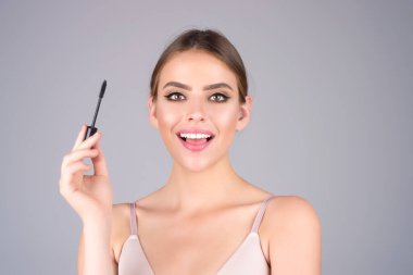 Woman comb eyebrows with eyebrow brush. Care for brows, eyebrows lamination. Brow beauty procedures. Beautiful woman with long eyelashes, eyebrows