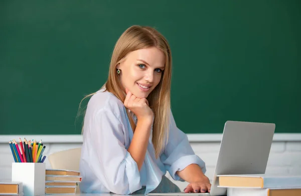 Student preparing exam and learning lessons in school classroom. Beautiful caucasian female student is studying in college remotely, distance learning, online education
